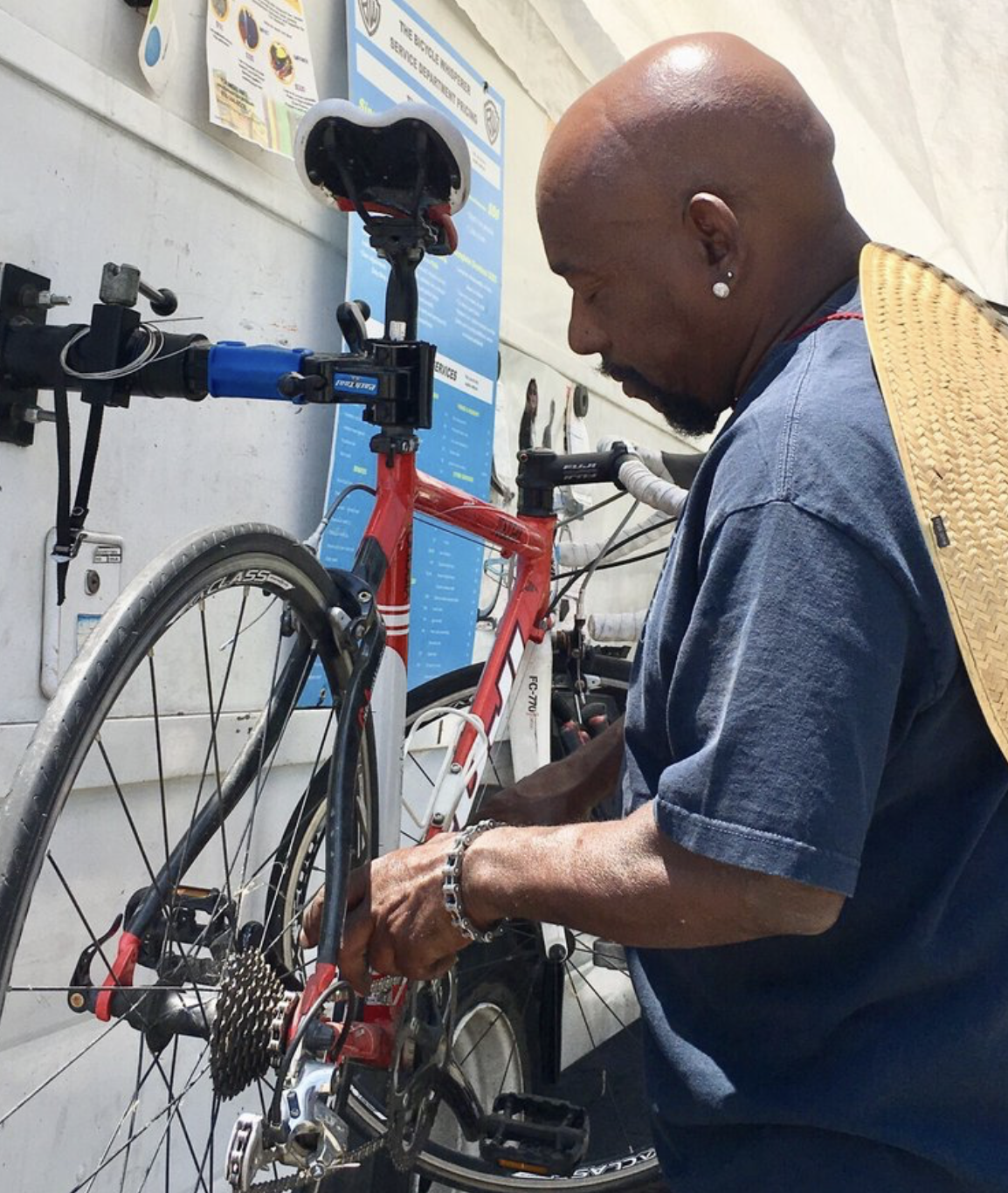 Lance's hands working on a bicycle drivetrain